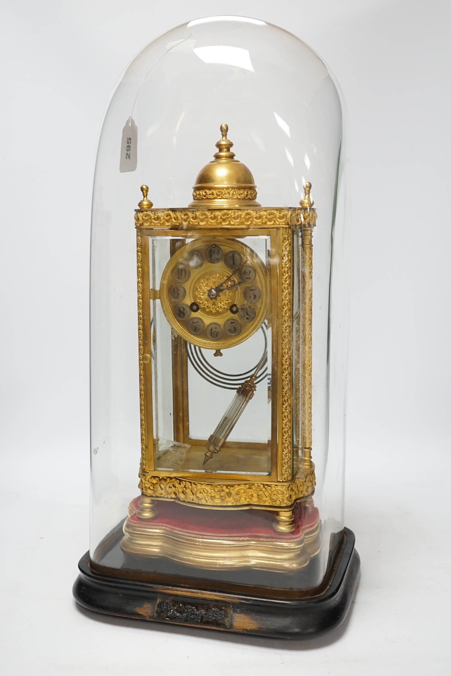 A French four glass mantel clock striking on a coiled gong with gilt brass frame and mercury pendulum, on a stand under a glass dome, 55cm high, with brass presentation label to stand dated December 1903